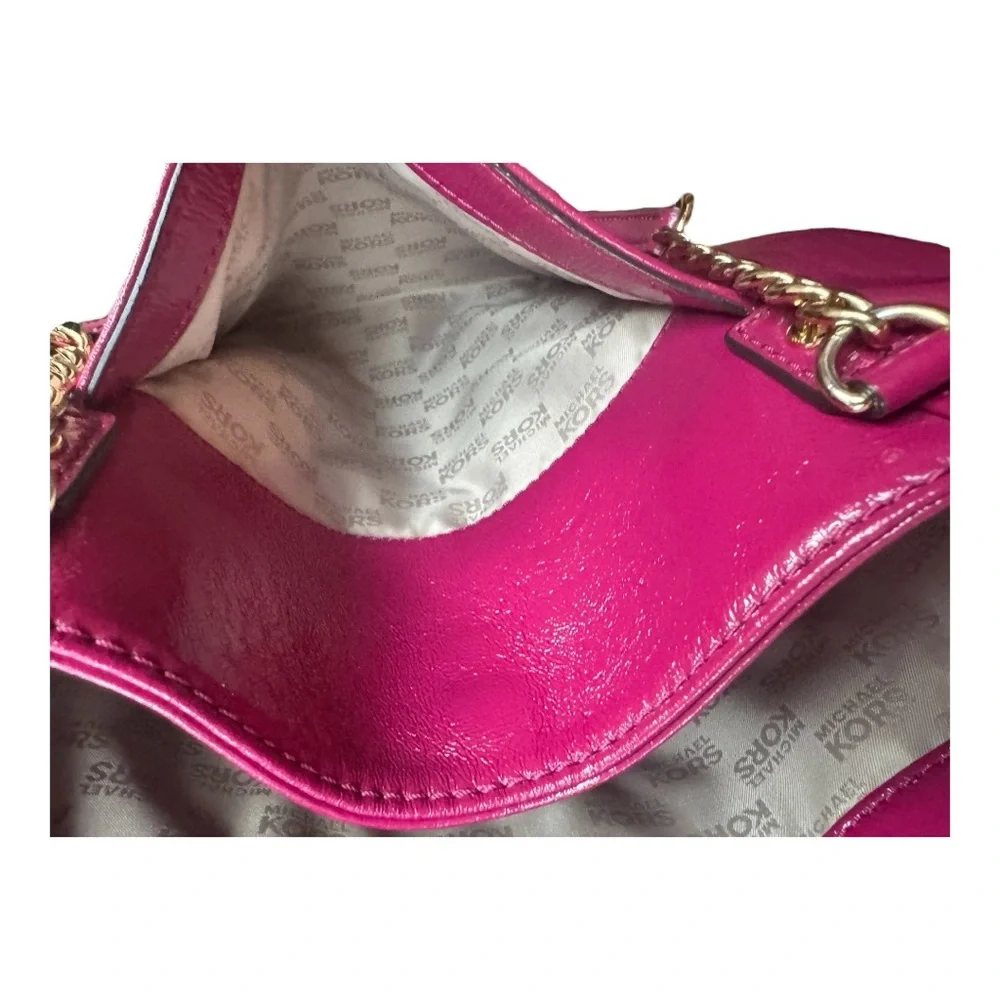 Michael Kors patent leather handbag in a sleek, glossy finish.
